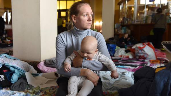 Ksenia, a 32-year-old from Kyiv, cradles her 6-month-old son Oleksandr