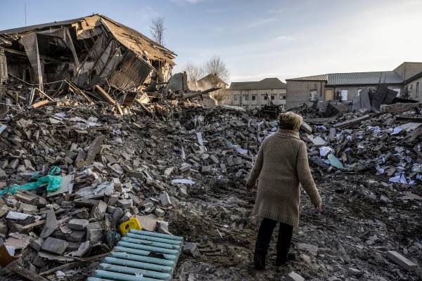 A hospital worker stands amid the rubble of the destroyed maternity ward in Vilnyansk, Ukraine.